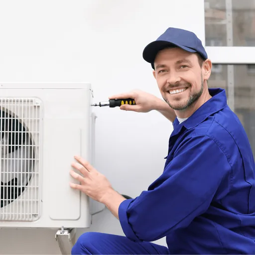 Technician servicing an outdoor condenser unit