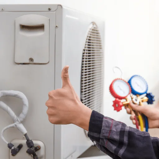 A thumbs-up beside the pressure gauges connected to an outdoor unit
