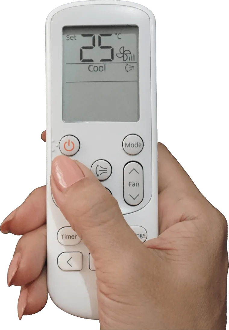 Hand holding an air conditioner remote set to 25 degrees on cool